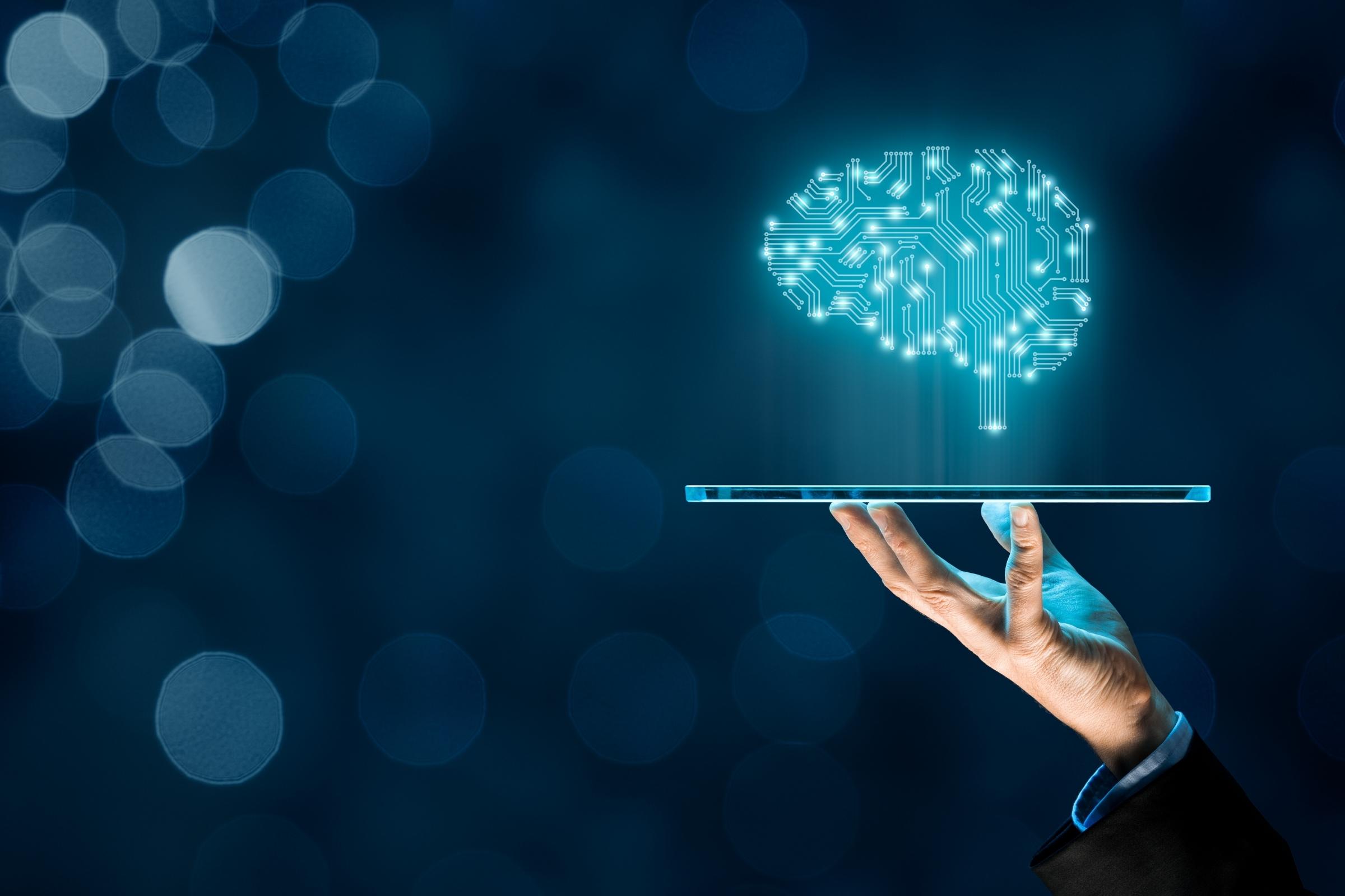 A digital brain image above the tablet which discribe's machine learning
